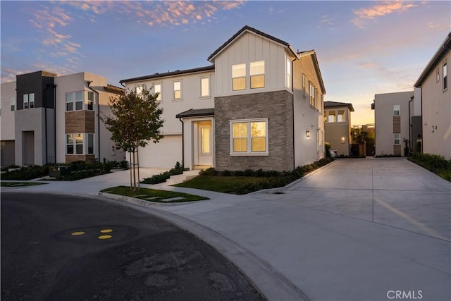 151 Fremont, Lake Forest, CA 92630 - view of front of house with concrete driveway, a garage, stone siding, and board and batten siding
