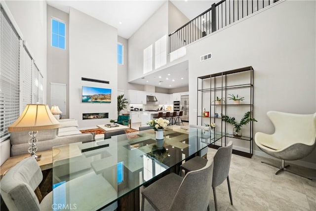 151 Fremont, Lake Forest, CA 92630 - dining room featuring a towering ceiling and a glass covered fireplace