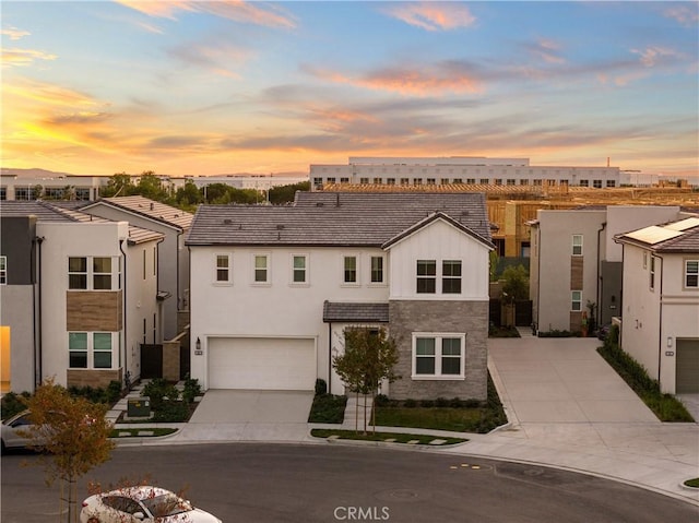 151 Fremont, Lake Forest, CA 92630 - view of front of home with driveway, stone siding, stucco siding, and an attached garage