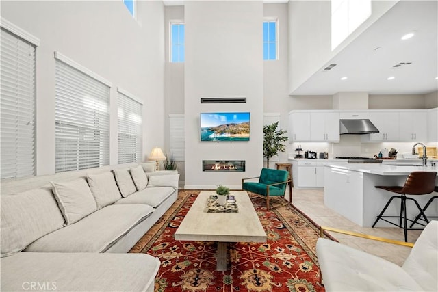 151 Fremont, Lake Forest, CA 92630 - living area featuring a towering ceiling and a glass covered fireplace