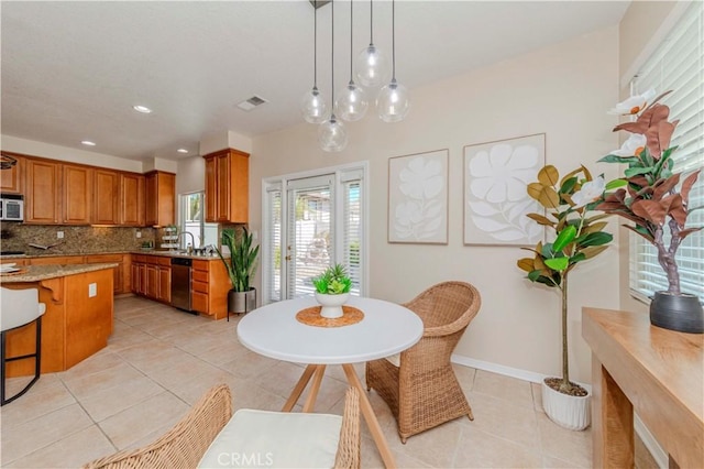 2142 Root St, Fullerton, CA 92833 - kitchen featuring white microwave, brown cabinets, dishwasher, light tile patterned floors, and tasteful backsplash