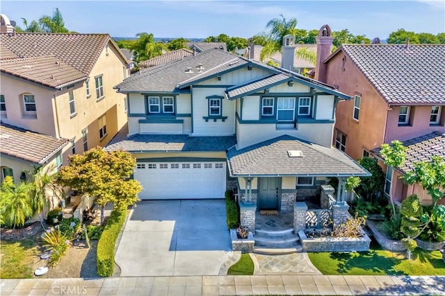 2142 Root St, Fullerton, CA 92833 - view of front of property featuring driveway, an attached garage, stucco siding, stone siding, and covered porch