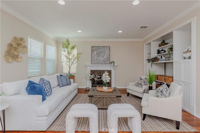 2142 Root St, Fullerton, CA 92833 - living area with a high end fireplace, wood finished floors, recessed lighting, crown molding, and built in features