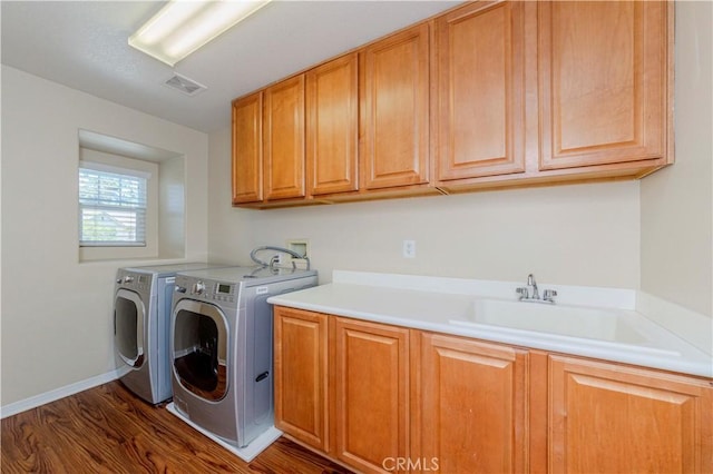 2142 Root St, Fullerton, CA 92833 - washroom with cabinet space, washing machine and clothes dryer, and dark wood-type flooring
