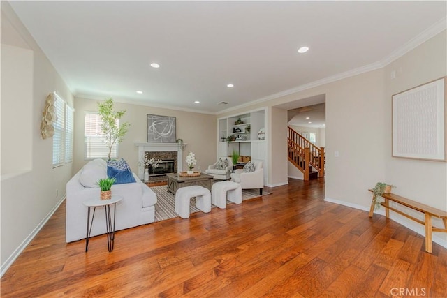 2142 Root St, Fullerton, CA 92833 - living room featuring wood finished floors, recessed lighting, a high end fireplace, stairs, and crown molding