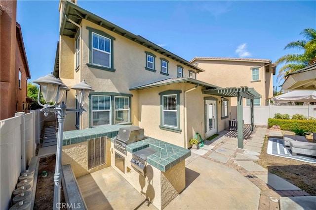 2142 Root St, Fullerton, CA 92833 - rear view of house featuring stucco siding, area for grilling, a pergola, a patio, and a fenced backyard