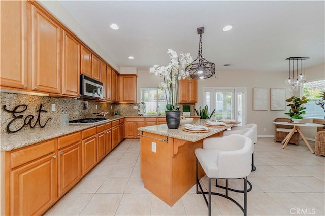 2142 Root St, Fullerton, CA 92833 - kitchen featuring stainless steel appliances, a breakfast bar area, plenty of natural light, backsplash, and recessed lighting