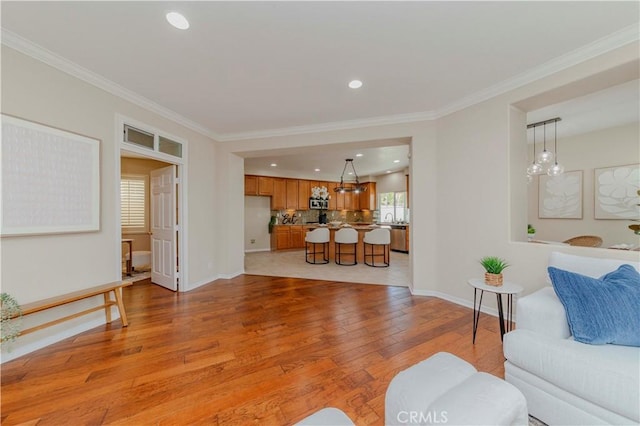 2142 Root St, Fullerton, CA 92833 - living room featuring light wood-style floors, ornamental molding, and recessed lighting