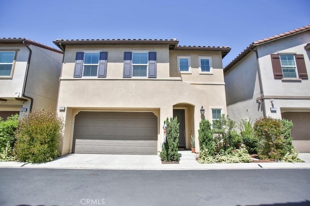 233 47th St, Long Beach, CA 90805 - mediterranean / spanish-style house featuring stucco siding, an attached garage, concrete driveway, and a tiled roof