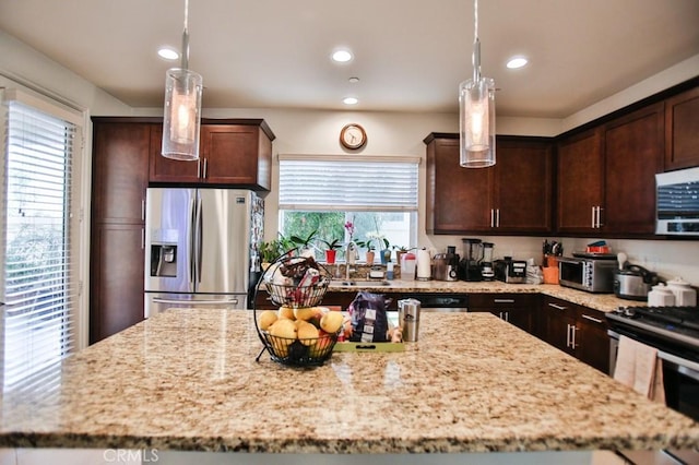 233 47th St, Long Beach, CA 90805 - kitchen with appliances with stainless steel finishes, dark brown cabinetry, light stone countertops, recessed lighting, and hanging light fixtures