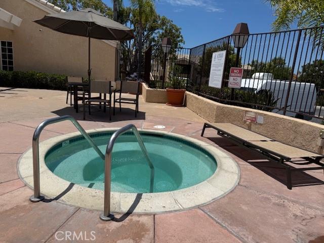 3211 Sello Ln Unit 100, Carlsbad, CA 92009 - view of swimming pool with a hot tub and a patio