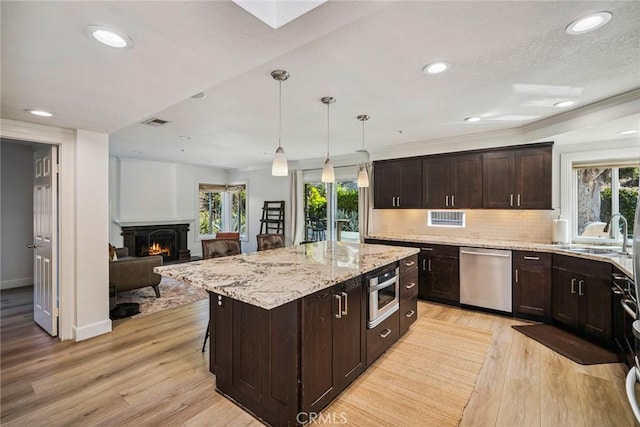 1205 Cerca, San Clemente, CA 92673 - kitchen featuring dishwasher, healthy amount of natural light, light stone countertops, light wood finished floors, and recessed lighting
