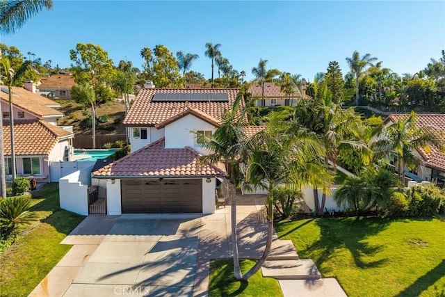 1205 Cerca, San Clemente, CA 92673 - mediterranean / spanish home with a tile roof, stucco siding, concrete driveway, roof mounted solar panels, and a garage
