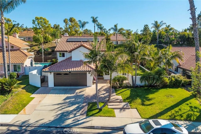 1205 Cerca, San Clemente, CA 92673 - mediterranean / spanish-style home with a tile roof, stucco siding, solar panels, driveway, and a residential view