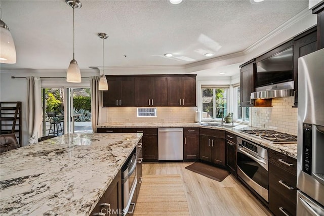 1205 Cerca, San Clemente, CA 92673 - kitchen with stainless steel appliances, light wood finished floors, ornamental molding, dark brown cabinetry, and a textured ceiling