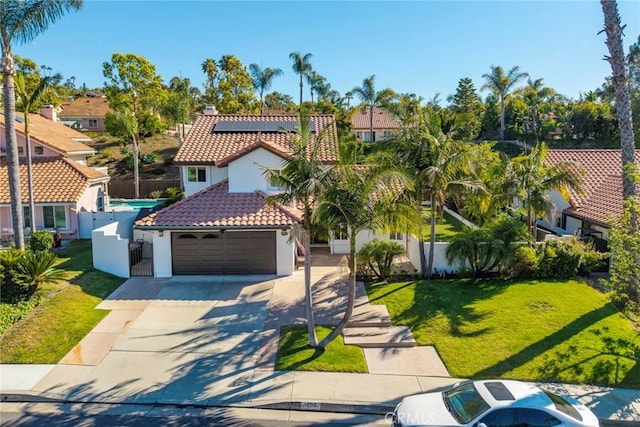 1205 Cerca, San Clemente, CA 92673 - mediterranean / spanish house featuring a tile roof, stucco siding, roof mounted solar panels, concrete driveway, and a residential view