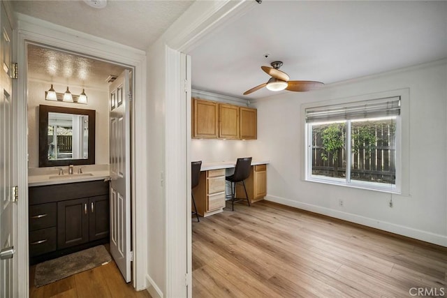 1205 Cerca, San Clemente, CA 92673 - interior space with ceiling fan, light wood-style flooring, built in desk, and crown molding