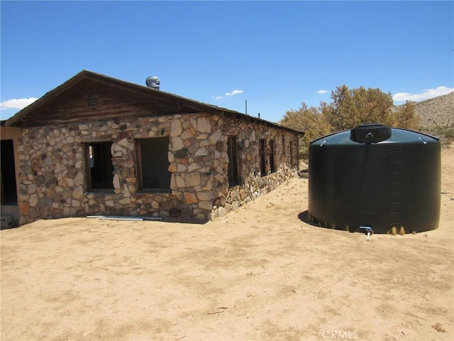 8626 La Contenta Rd, Yucca Valley, CA 92284 - view of side of home featuring stone siding
