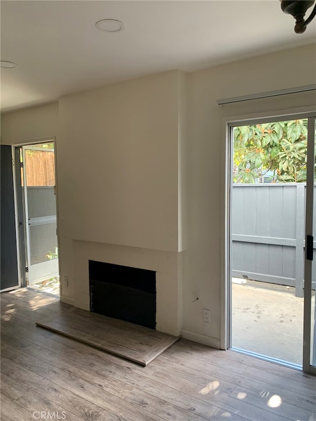 5236 Kester Ave Unit 6, Sherman Oaks, CA 91411 - unfurnished living room with a fireplace with raised hearth and wood finished floors