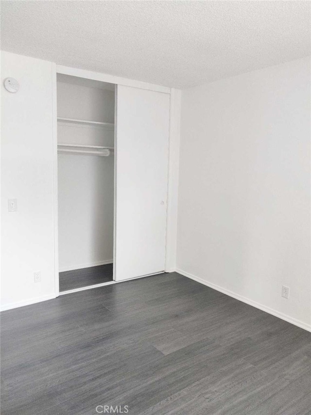 5236 Kester Ave Unit 6, Sherman Oaks, CA 91411 - unfurnished bedroom with a textured ceiling, dark wood-style flooring, and a closet