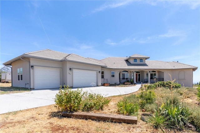 4620 Sandpiper Ln, Paradise, CA 95969 - view of front of house featuring an attached garage, concrete driveway, a porch, and stucco siding