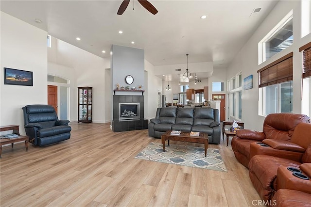 4620 Sandpiper Ln, Paradise, CA 95969 - living area with ceiling fan, light wood-type flooring, a high ceiling, a tile fireplace, and recessed lighting