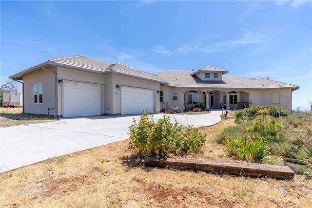 4620 Sandpiper Ln, Paradise, CA 95969 - view of front facade featuring a garage, concrete driveway, a porch, and stucco siding