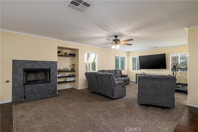 1649 Wrentree Way, Hemet, CA 92545 - living room with ornamental molding, healthy amount of natural light, ceiling fan, a tile fireplace, and wood finished floors