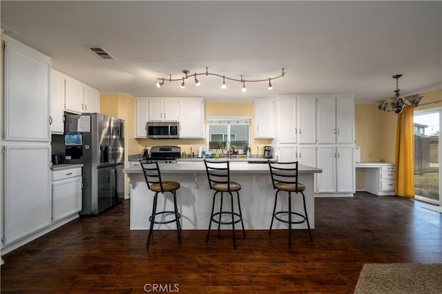 1649 Wrentree Way, Hemet, CA 92545 - kitchen featuring stainless steel appliances, a chandelier, a kitchen breakfast bar, white cabinetry, and ornamental molding