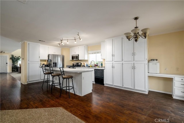 1649 Wrentree Way, Hemet, CA 92545 - kitchen featuring appliances with stainless steel finishes, dark wood-style flooring, a chandelier, white cabinets, and ornamental molding