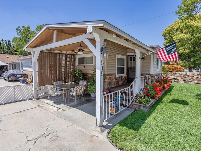515 N Shelton St, Burbank, CA 91506 - view of front facade featuring ceiling fan, a front lawn, stone siding, and a patio