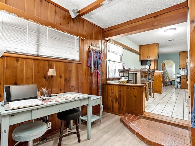 515 N Shelton St, Burbank, CA 91506 - office area with arched walkways, beamed ceiling, wood walls, a textured ceiling, and light wood-type flooring