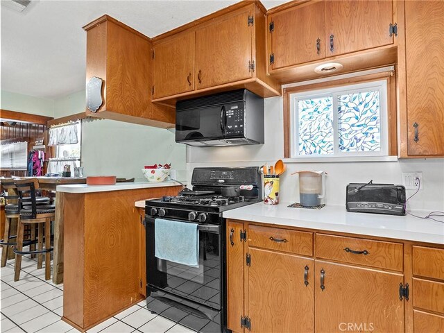 515 N Shelton St, Burbank, CA 91506 - kitchen featuring black appliances, light tile patterned floors, and light countertops