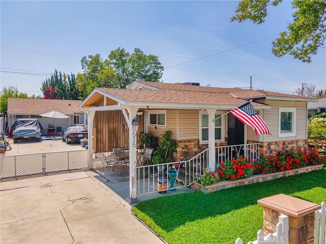 515 N Shelton St, Burbank, CA 91506 - view of front facade with stone siding, roof with shingles, covered porch, and a front lawn