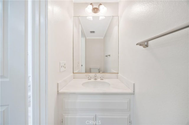 29282 Rue Cerise Unit 7, Laguna Niguel, CA 92677 - half bath featuring vanity and crown molding