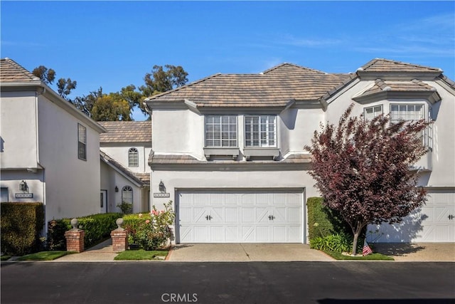 29282 Rue Cerise Unit 7, Laguna Niguel, CA 92677 - view of front of property with stucco siding, an attached garage, and driveway