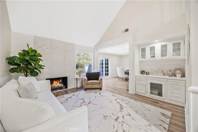 29282 Rue Cerise Unit 7, Laguna Niguel, CA 92677 - living area featuring a fireplace, light wood-type flooring, and high vaulted ceiling