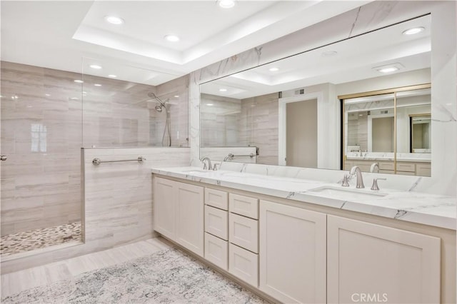 29282 Rue Cerise Unit 7, Laguna Niguel, CA 92677 - full bath featuring a walk in shower, double vanity, a raised ceiling, recessed lighting, and tile walls
