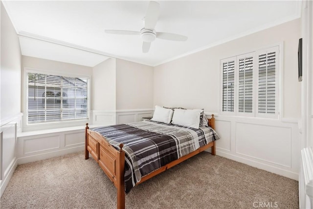 29282 Rue Cerise Unit 7, Laguna Niguel, CA 92677 - bedroom with a decorative wall, light carpet, ornamental molding, wainscoting, and ceiling fan