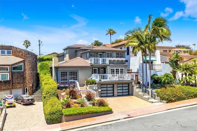 210 W Avenida Gaviota, San Clemente, CA 92672 - view of front of property with stucco siding, an attached garage, stairway, driveway, and a balcony