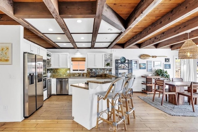 210 W Avenida Gaviota, San Clemente, CA 92672 - kitchen featuring stainless steel appliances, open shelves, light wood-type flooring, dark countertops, and beamed ceiling