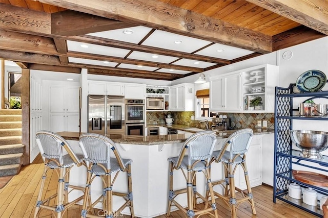 210 W Avenida Gaviota, San Clemente, CA 92672 - kitchen with appliances with stainless steel finishes, open shelves, light wood-type flooring, white cabinetry, and decorative backsplash