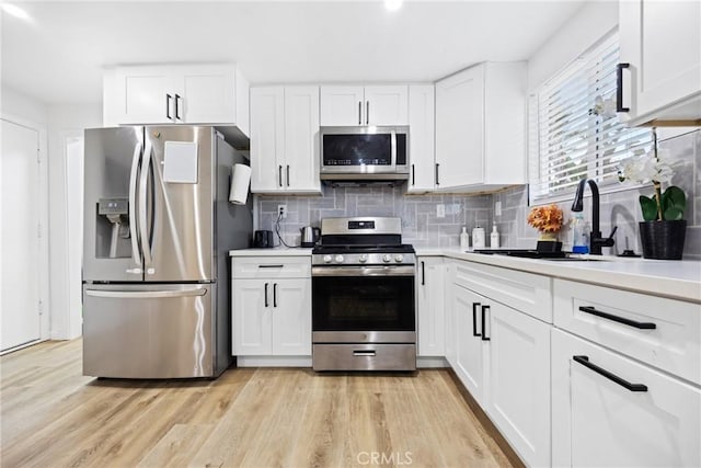 107 E Johnson St, Compton, CA 90220 - kitchen featuring appliances with stainless steel finishes, white cabinets, light countertops, and decorative backsplash