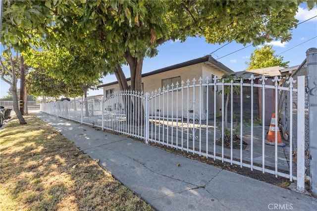 107 E Johnson St, Compton, CA 90220 - view of front facade featuring a fenced front yard and stucco siding