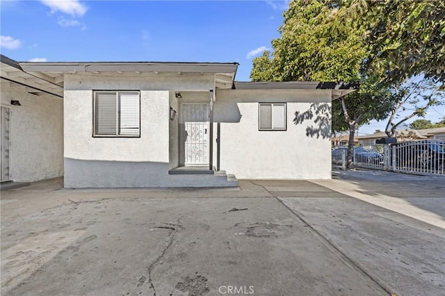 107 E Johnson St, Compton, CA 90220 - view of front facade featuring stucco siding and a patio area