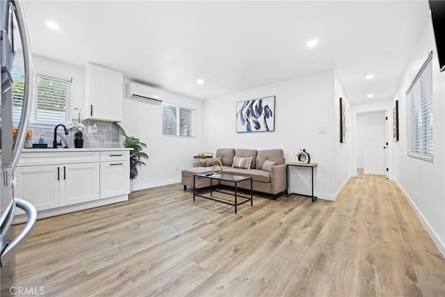107 E Johnson St, Compton, CA 90220 - living area featuring a wall unit AC, light wood-style floors, and recessed lighting