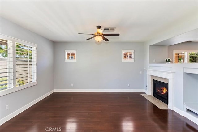 6701 Whitewater St, Eastvale, CA 91752 - unfurnished living room featuring a ceiling fan, dark wood-style floors, healthy amount of natural light, and a high end fireplace
