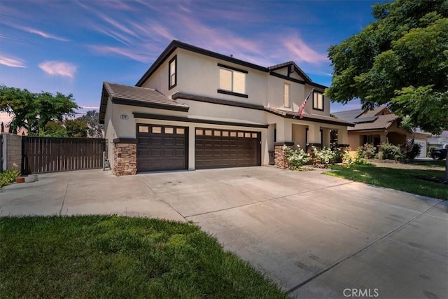 6701 Whitewater St, Eastvale, CA 91752 - tudor home with stucco siding, concrete driveway, stone siding, a tile roof, and a garage