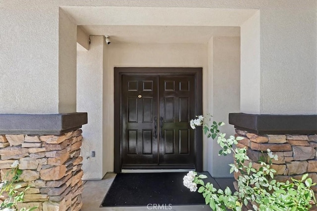 6701 Whitewater St, Eastvale, CA 91752 - property entrance featuring stucco siding and stone siding