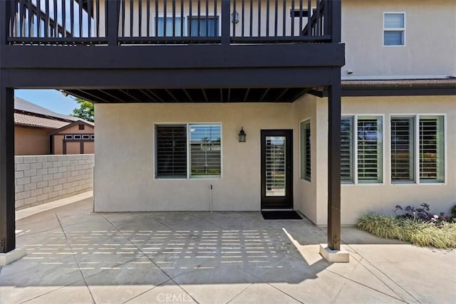 6701 Whitewater St, Eastvale, CA 91752 - view of exterior entry featuring stucco siding, a patio, and a balcony